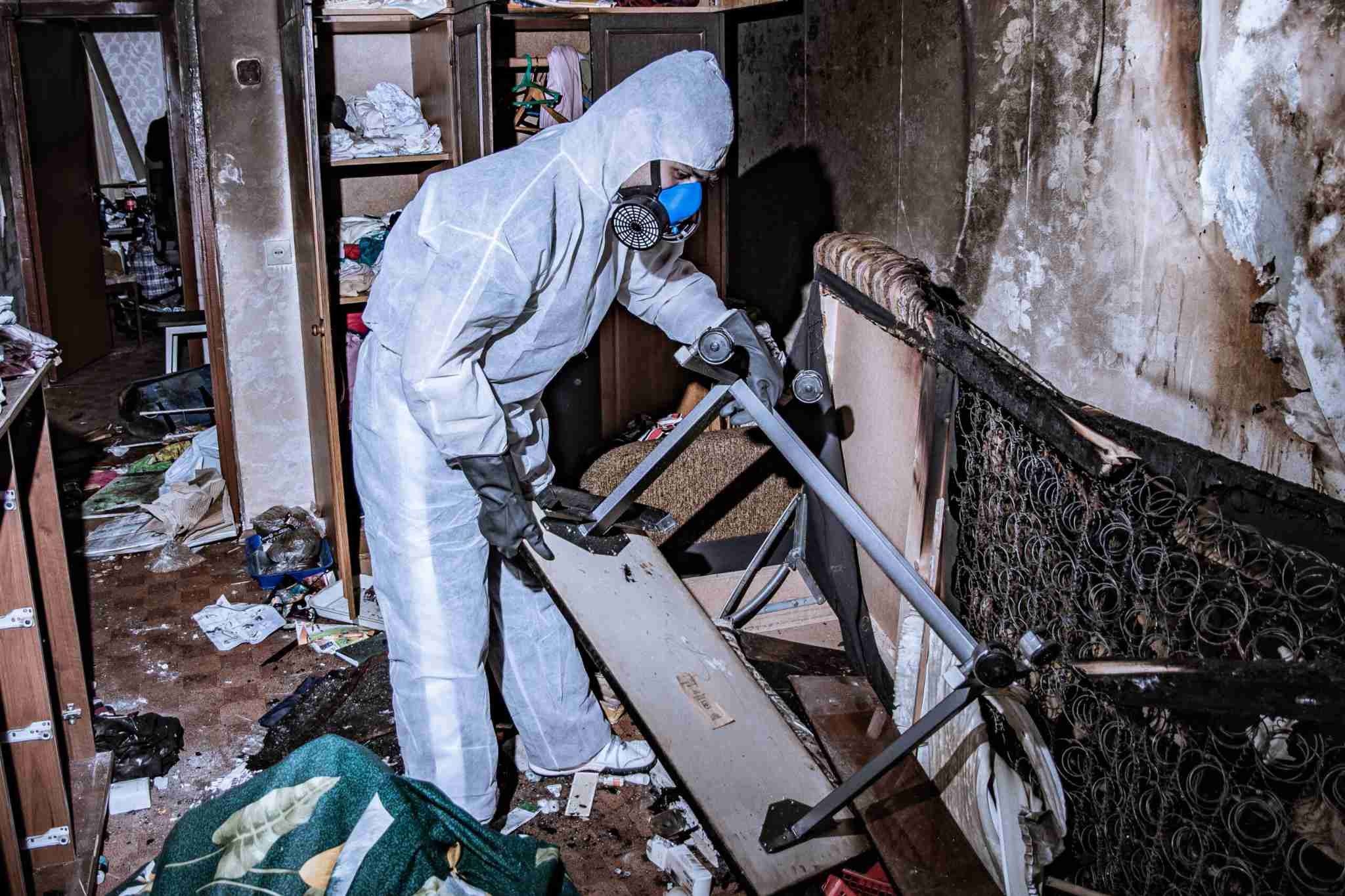 Paul Davis Restoration technician performing fire damage cleanup and smoke restoration services inside a heavily damaged home in Portland and Vancouver.