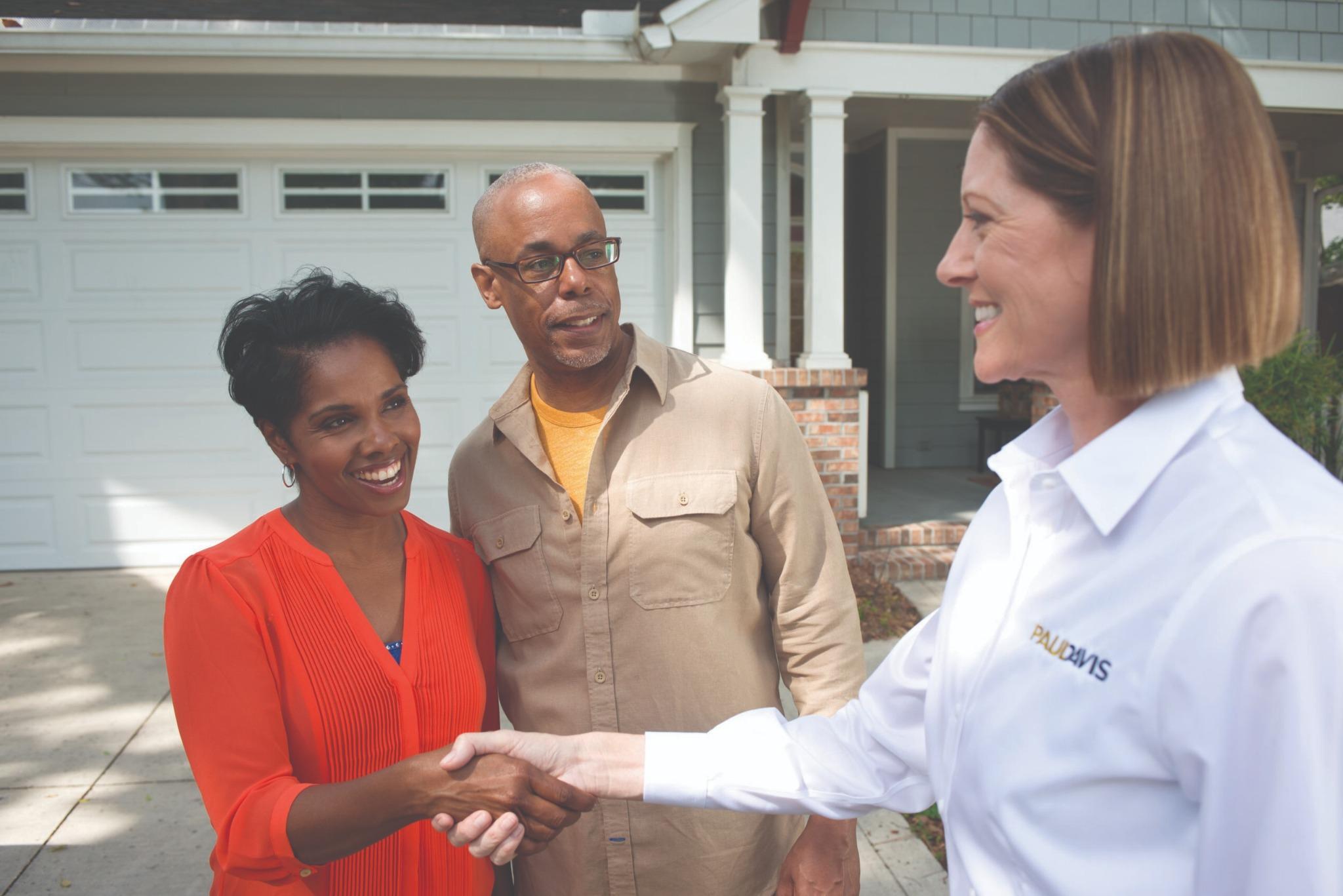 Paul Davis Restoration representative shaking hands with homeowners after property inspection and restoration consultation in Portland Vancouver area.